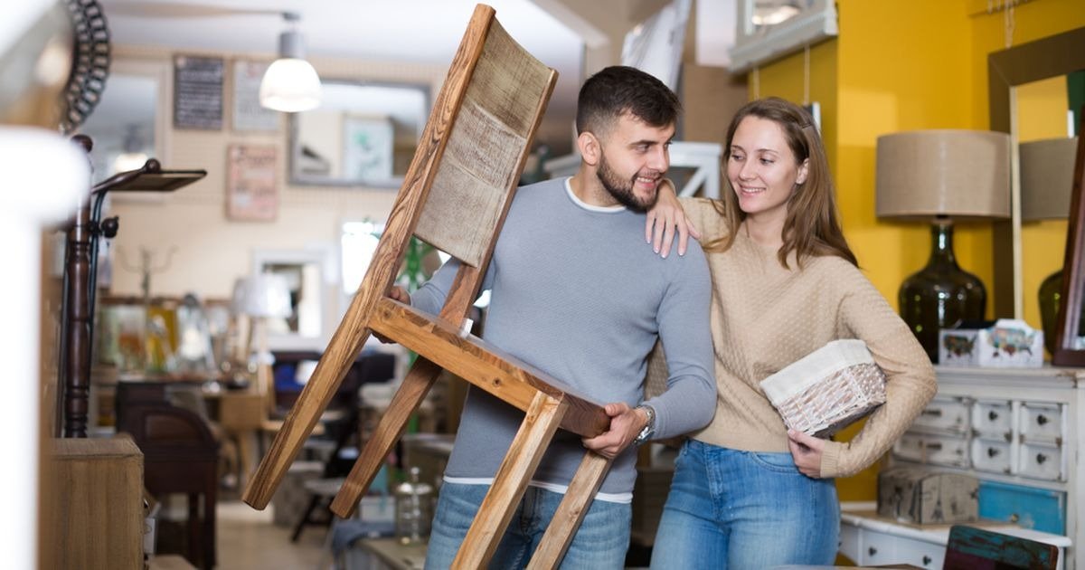 Couple arranging furniture for rental property