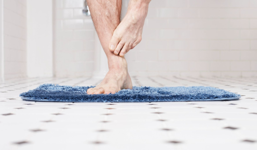 Man using bath mat