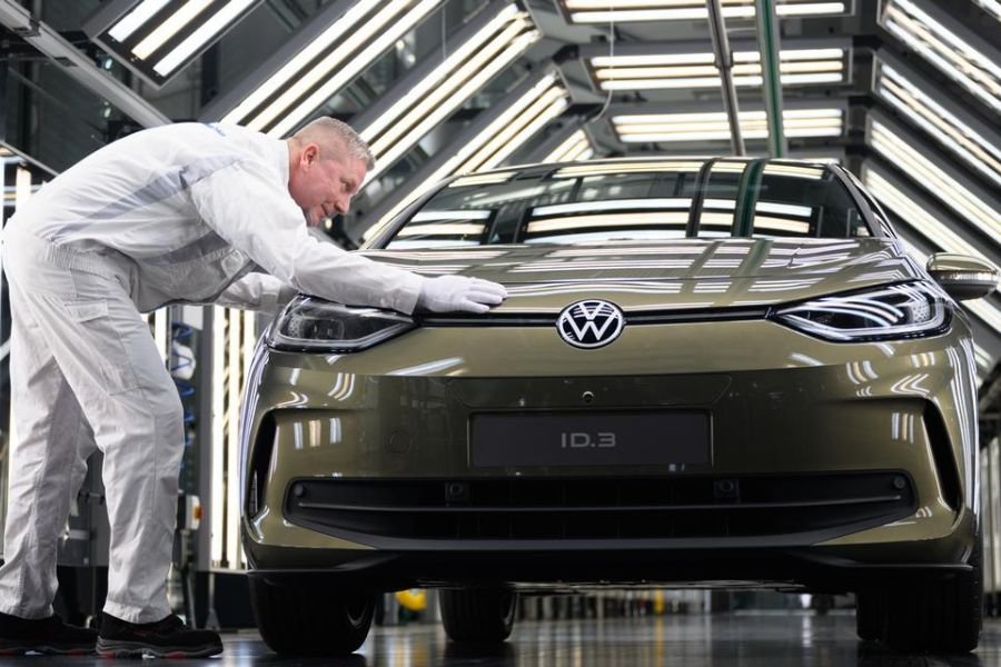 Mechanic working on exhaust tips of Volkswagen